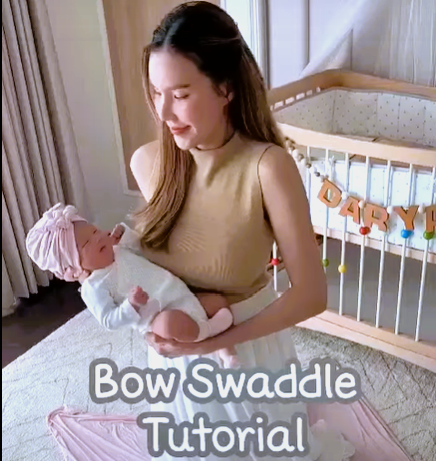 Load video: How to tie a bow swaddle